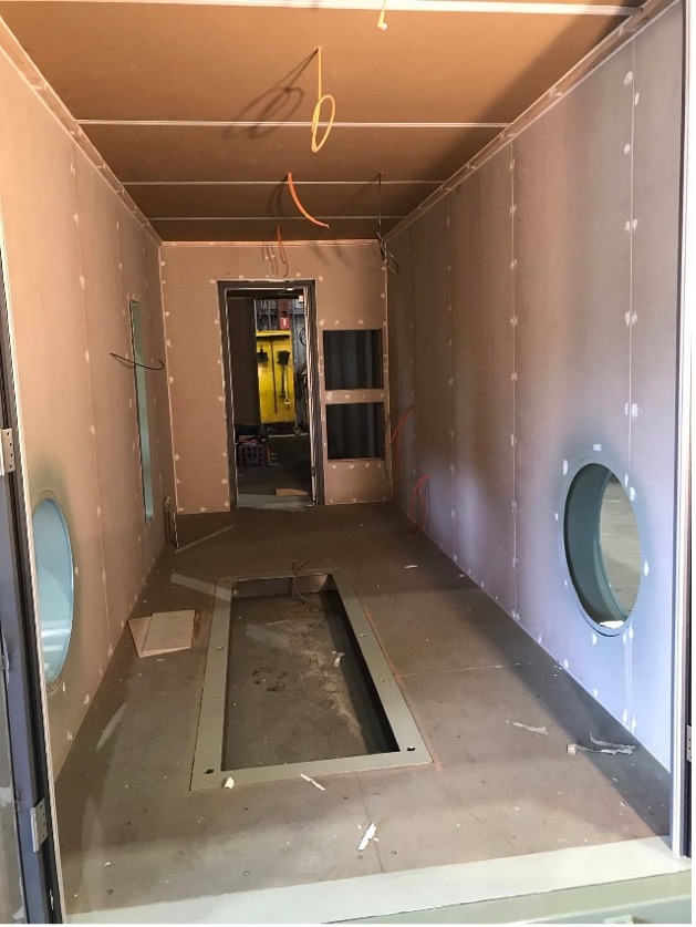Internal fit out of 40-foot container. Walls have been installed and electric cable fitted